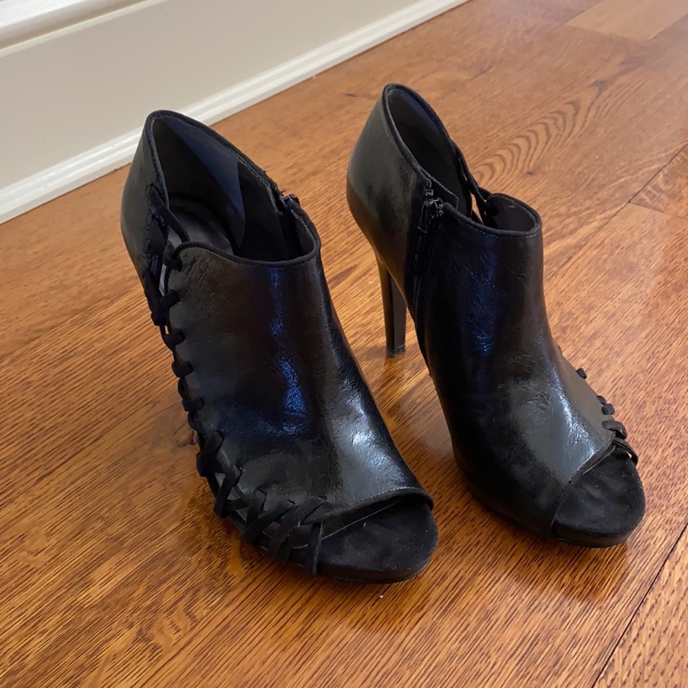 Black leather peep toe booties with crisscross sides. Size 7.5